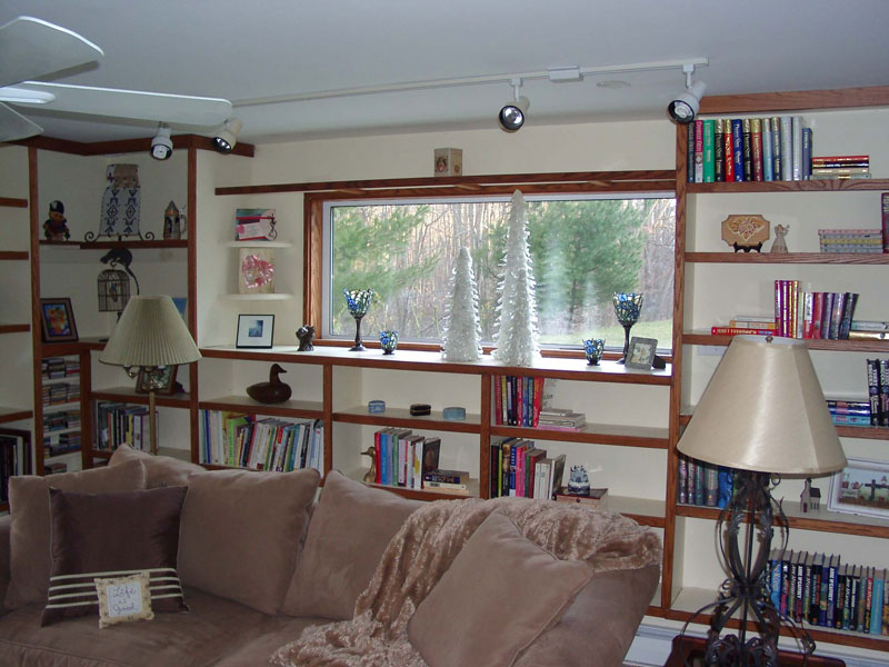 Built-in bookshelves with wood stained in contrasting color adds appeal to this room.
