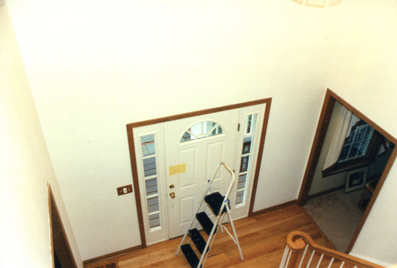 This entryway looks bland before Kelley Carpentry added wainscot and other molding trim to define it.